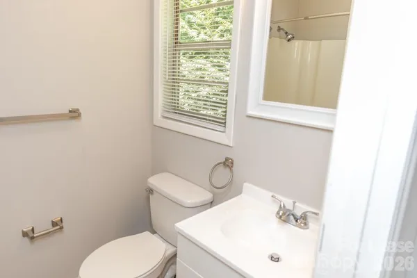 a white toilet sitting next to a bathroom sink