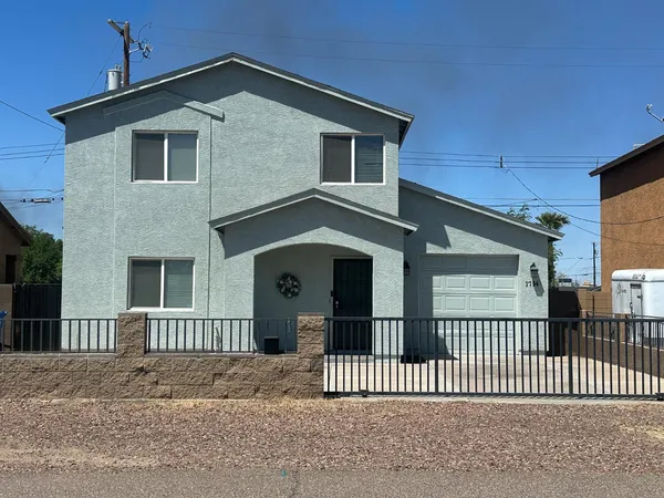 a front view of a house with iron fence