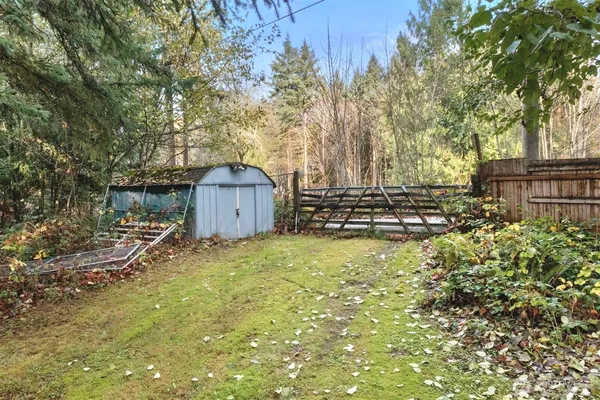a backyard of a house with table and chairs