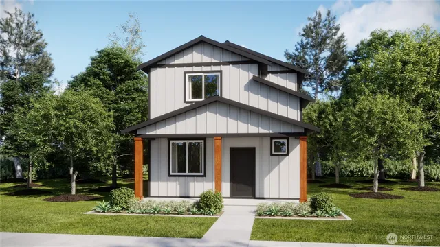a front view of a house with a yard and trees