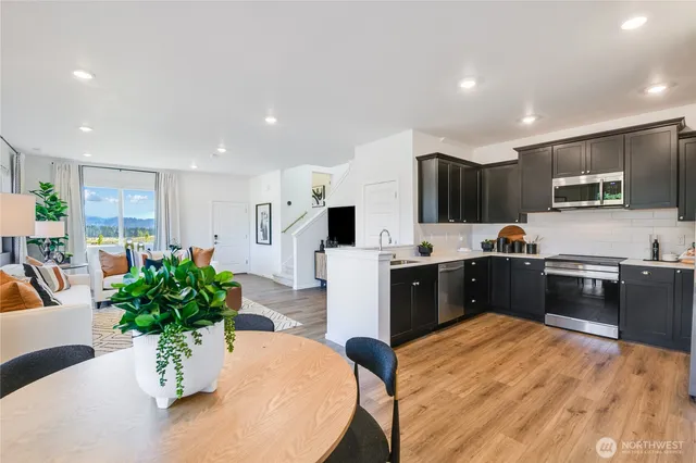 a large kitchen with stainless steel appliances lots of counter top space