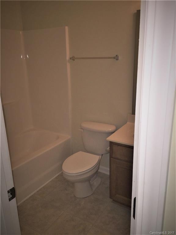 2137 Midnight Blue Lane, Unit 186 Fort Mill, SC 29708 - Photo 13 of 14 a white toilet sitting next to a bath tub