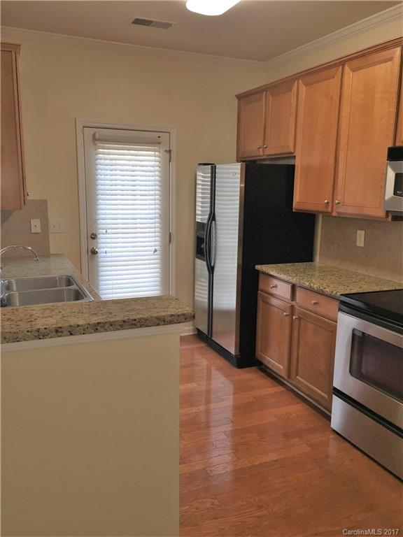 2137 Midnight Blue Lane, Unit 186 Fort Mill, SC 29708 - Photo 4 of 14 a kitchen with granite countertop a refrigerator stove and microwave