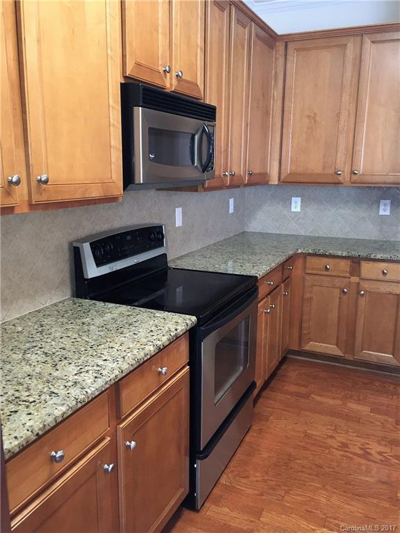 2137 Midnight Blue Lane, Unit 186 Fort Mill, SC 29708 - Photo 5 of 14 a kitchen with granite countertop cabinets stainless steel appliances and a counter space