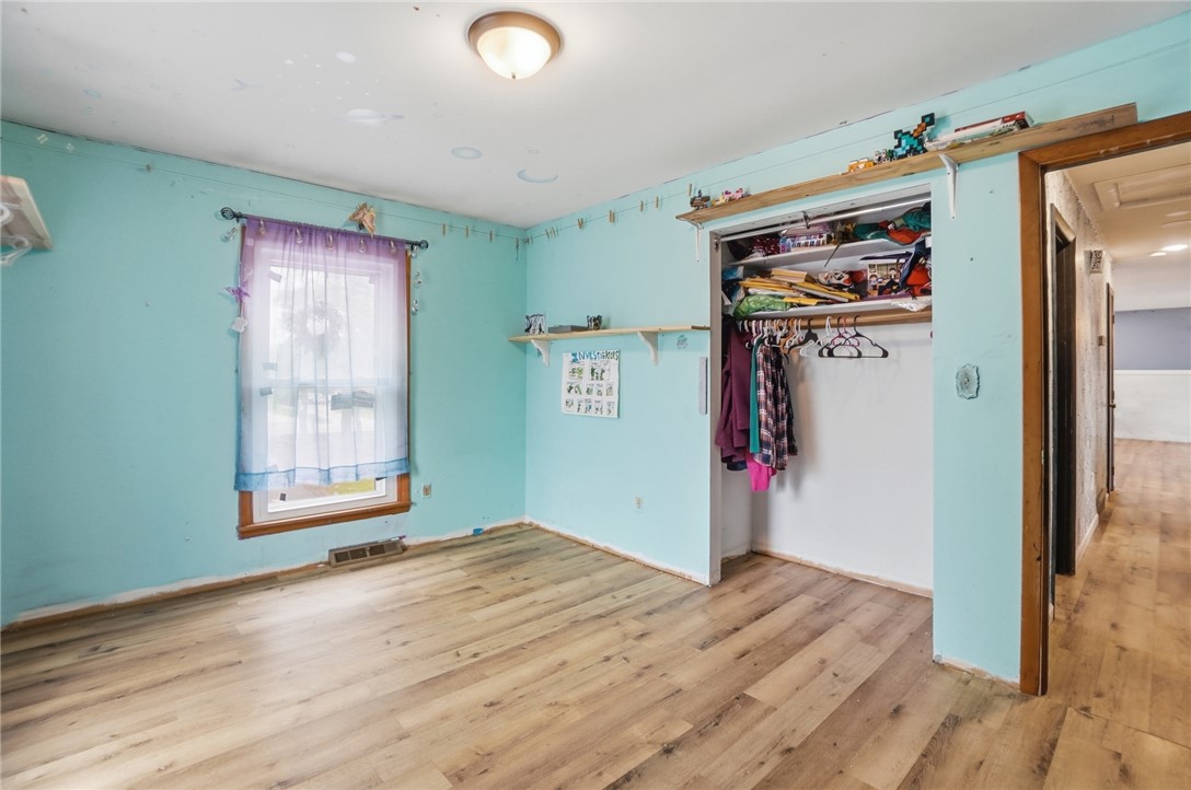 290 Ginghamsburg Road Tipp City, OH 45371 - Photo 24 of 49 This spacious bedroom offers ample natural light and durable flooring, ideal for comfortable living.