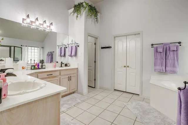 a spacious bathroom with a sink vanity and a mirror