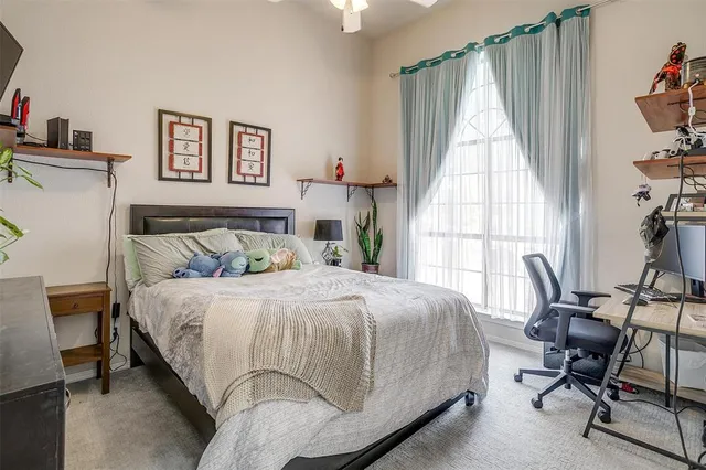 a bedroom with a bed and a tv on table