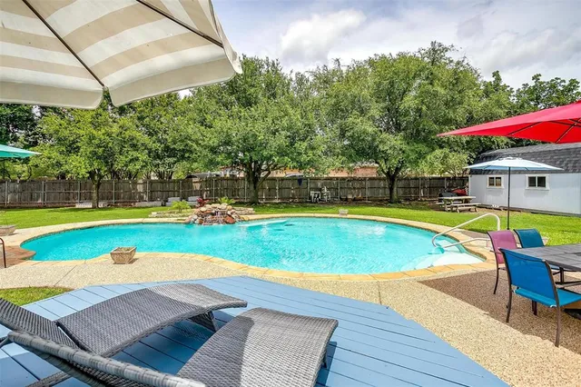 a view of deck with chairs and an umbrella
