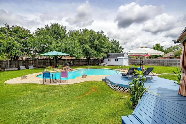 a view of a table and chairs in backyard