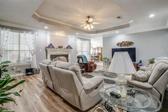 a living room with furniture a large window and a chandelier