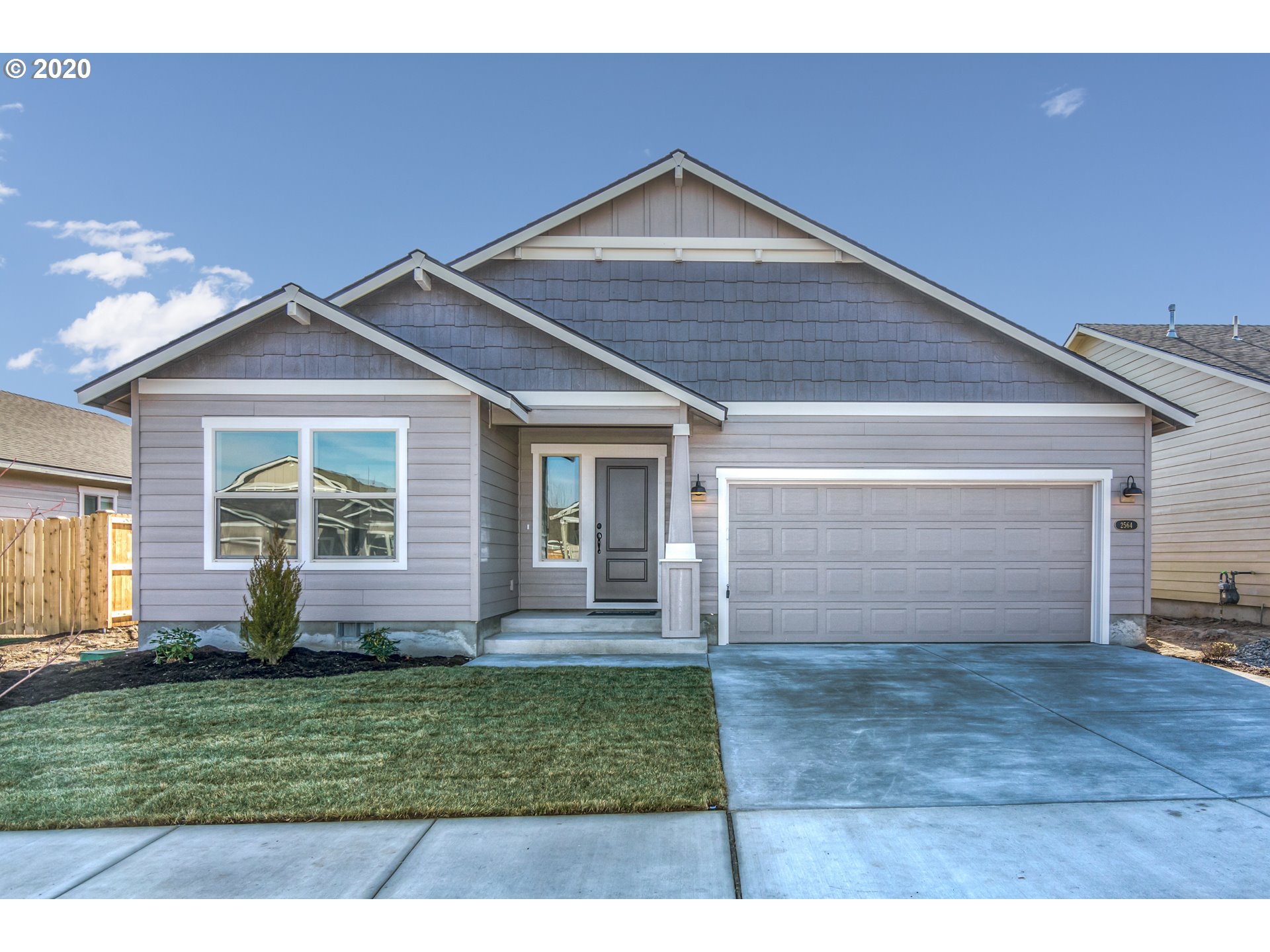 475 South 10th Street Monroe, OR 97456 - Photo 1 of 24 a front view of a house with a garden and yard