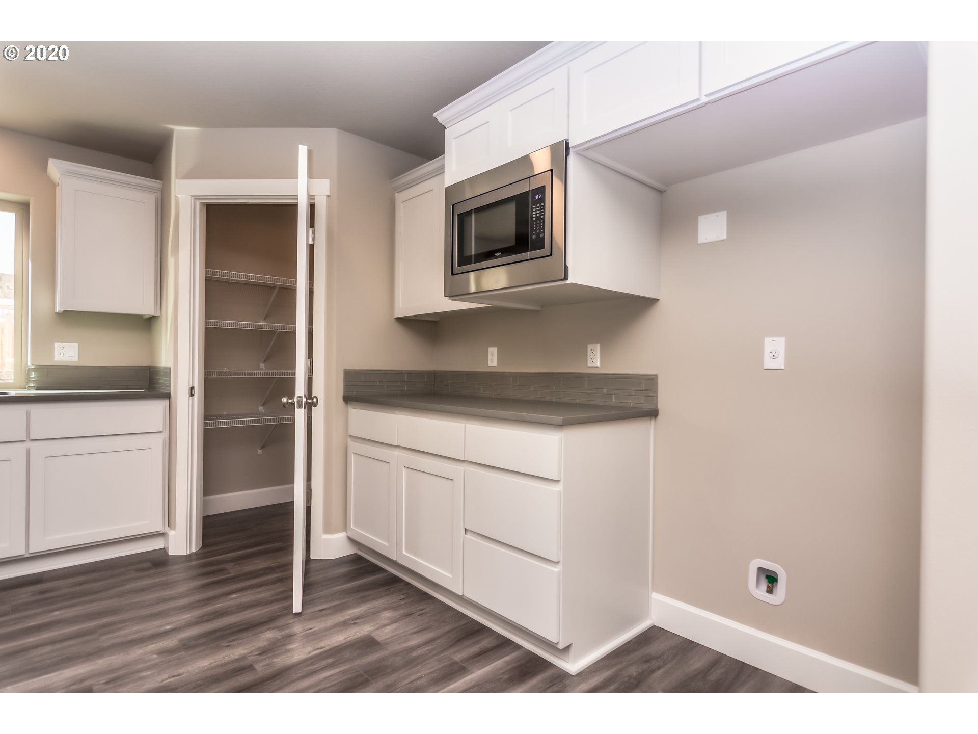 475 South 10th Street Monroe, OR 97456 - Photo 14 of 24 a kitchen with granite countertop white cabinets and stainless steel appliances