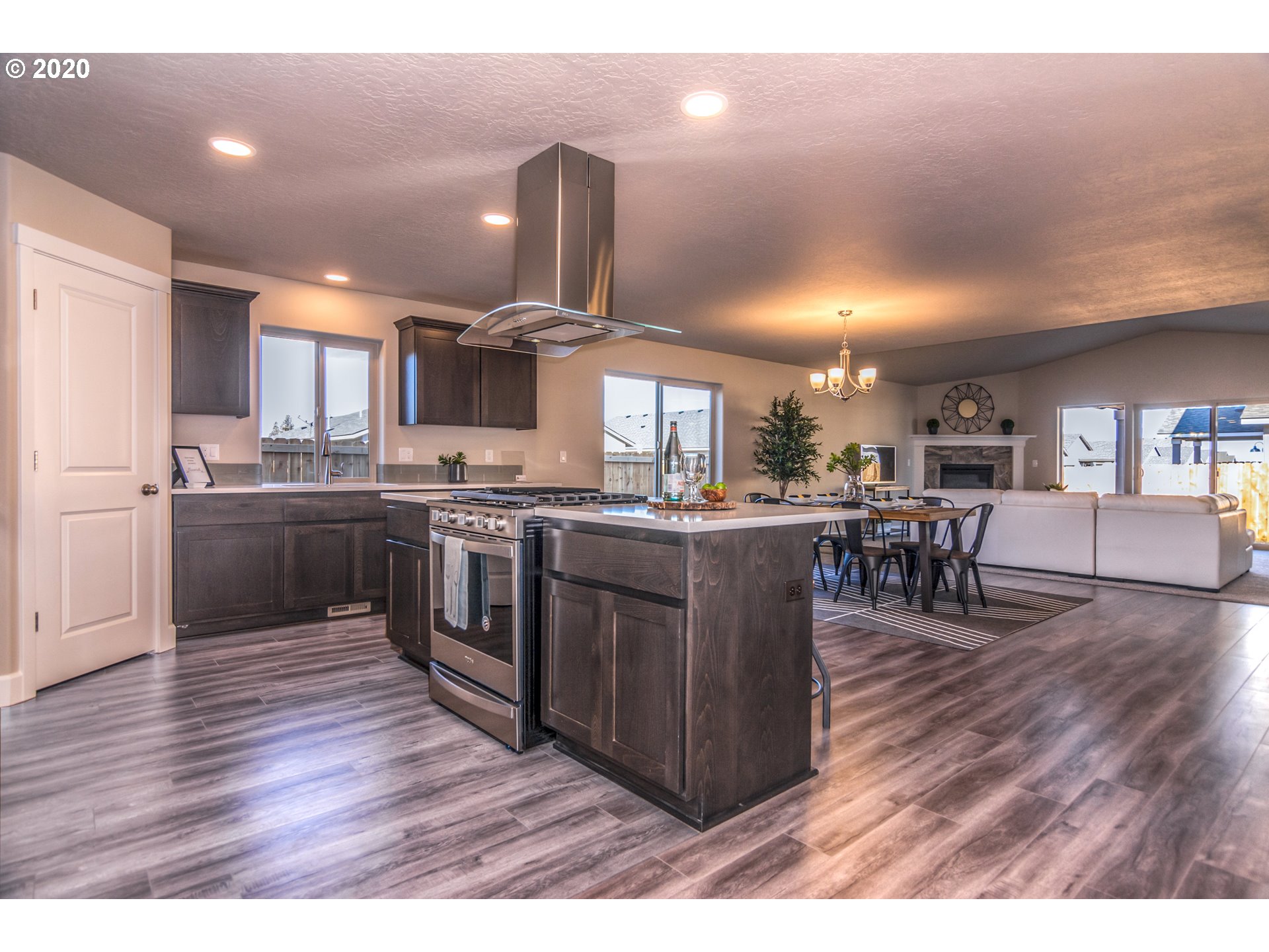 475 South 10th Street Monroe, OR 97456 - Photo 18 of 24 a kitchen with stainless steel appliances granite countertop a stove a sink a microwave a center island and chairs