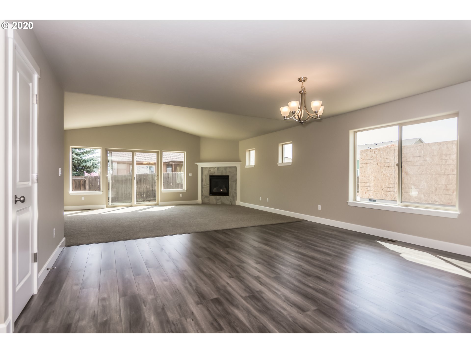 475 South 10th Street Monroe, OR 97456 - Photo 7 of 24 an empty room with wooden floor and windows