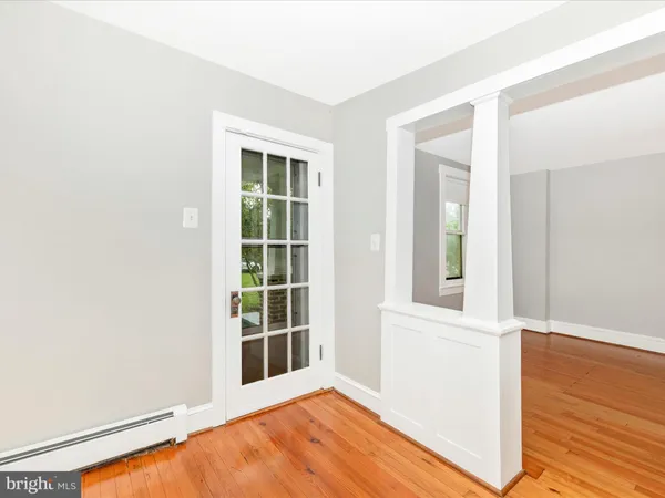 an empty room with a window and a ceiling fan