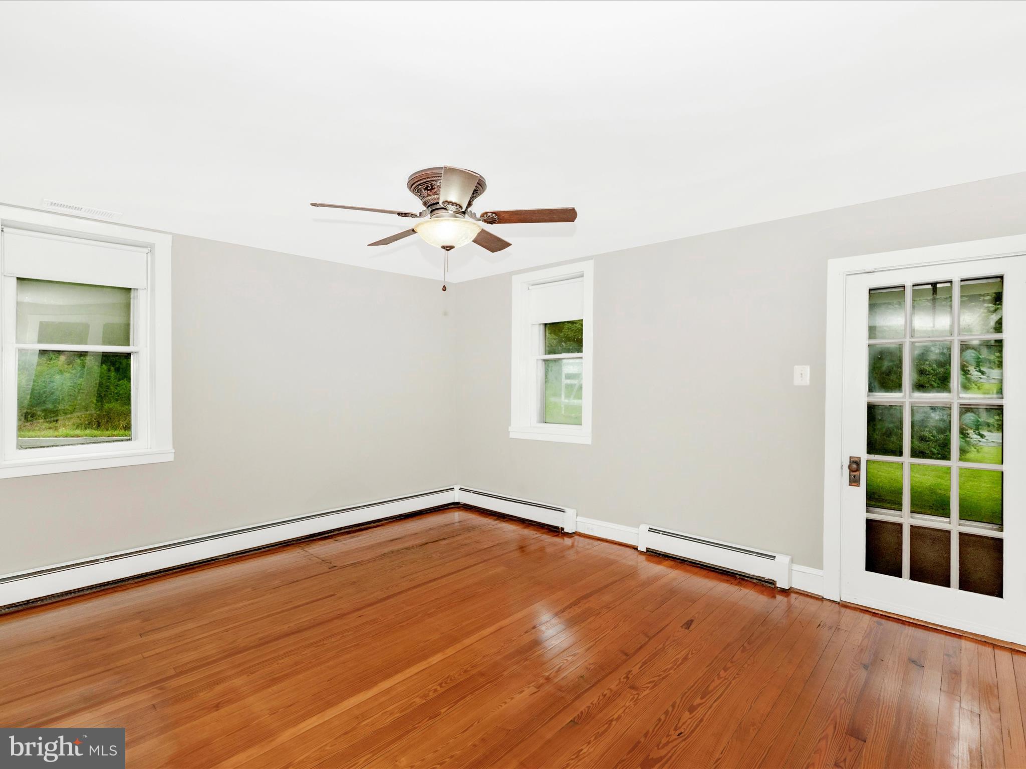 12261 Baugher Road Thurmont, MD 21788 - Photo 14 of 61 an empty room with wooden floor and windows