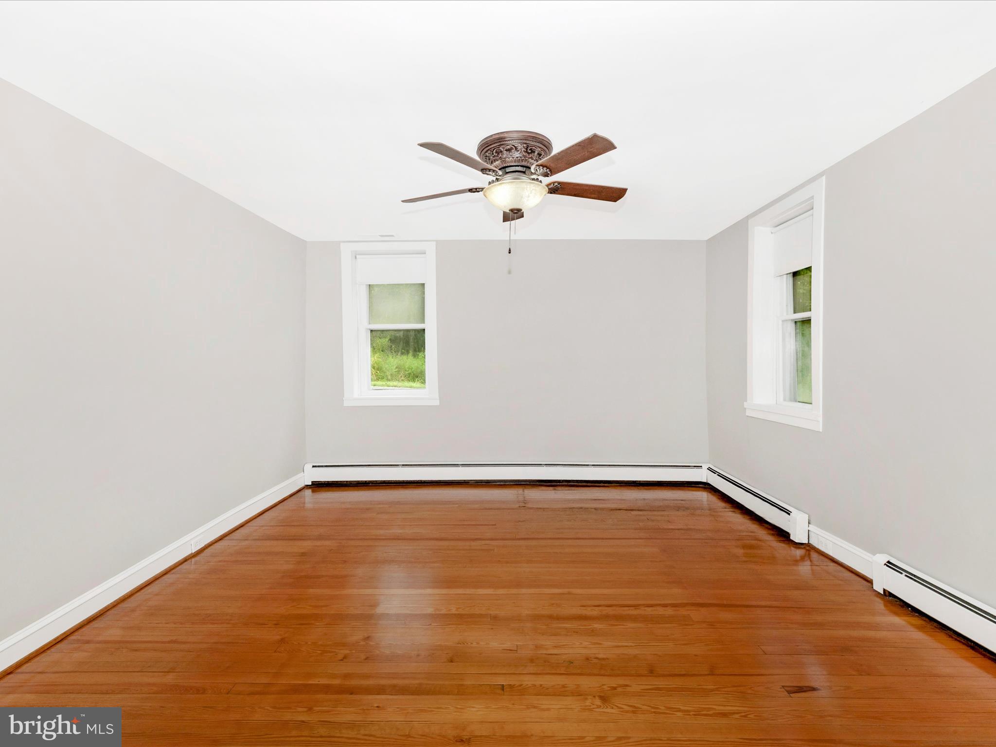 12261 Baugher Road Thurmont, MD 21788 - Photo 15 of 61 a view of a room with wooden floor and ceiling fan
