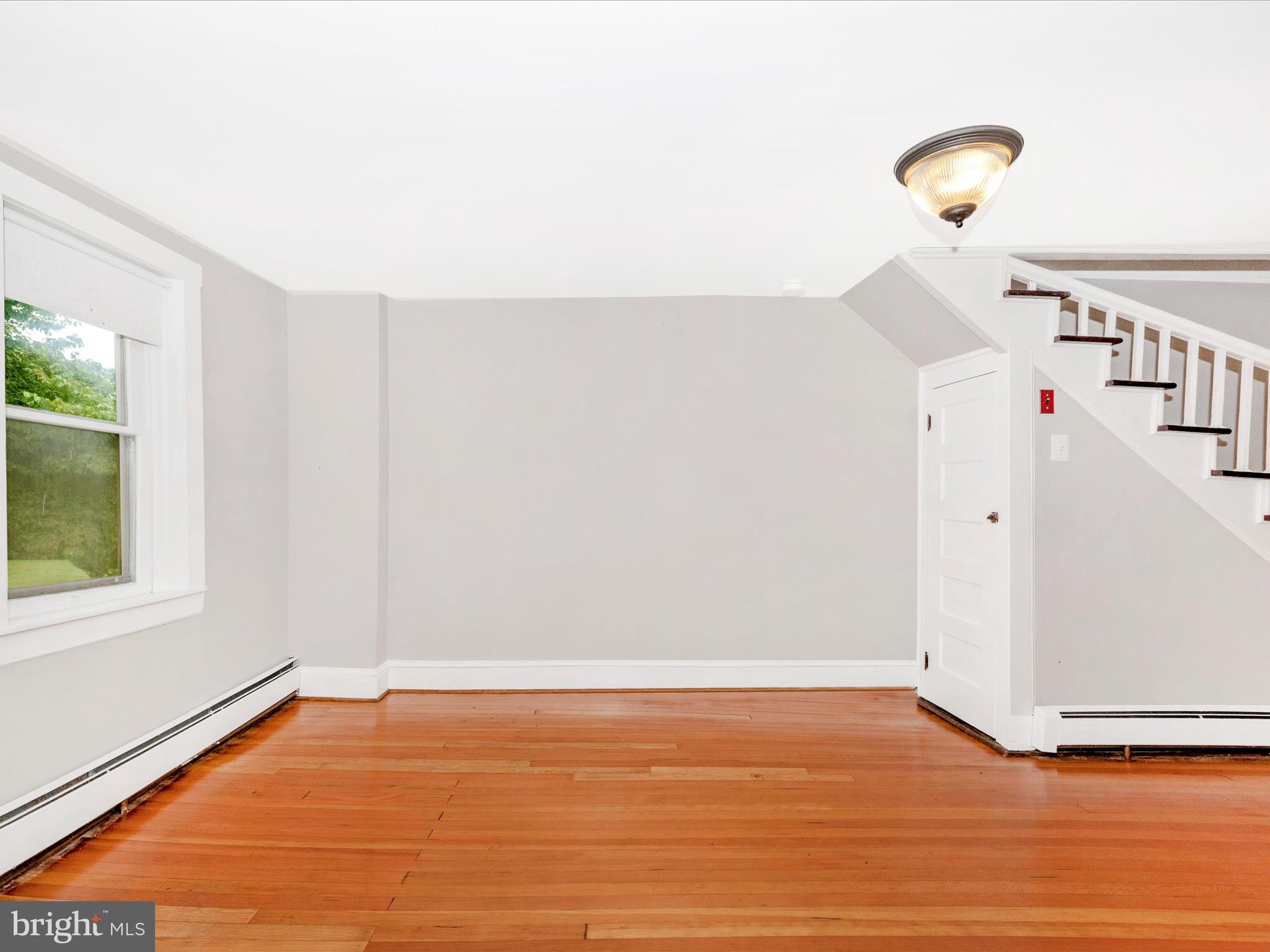 12261 Baugher Road Thurmont, MD 21788 - Photo 18 of 61 a view of an empty room with wooden floor and a window