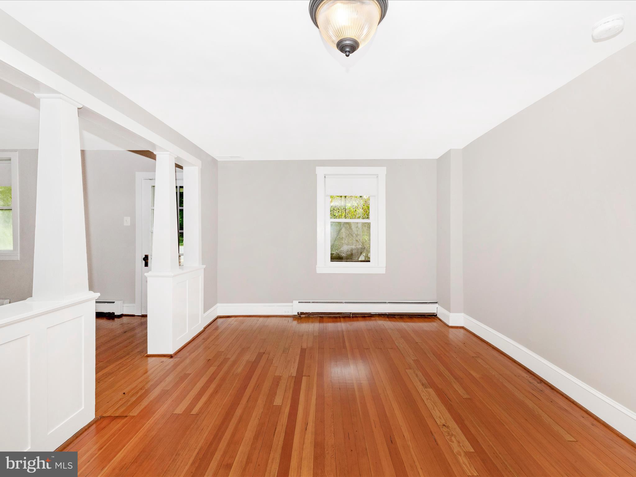 12261 Baugher Road Thurmont, MD 21788 - Photo 21 of 61 a view of an empty room with wooden floor and a window