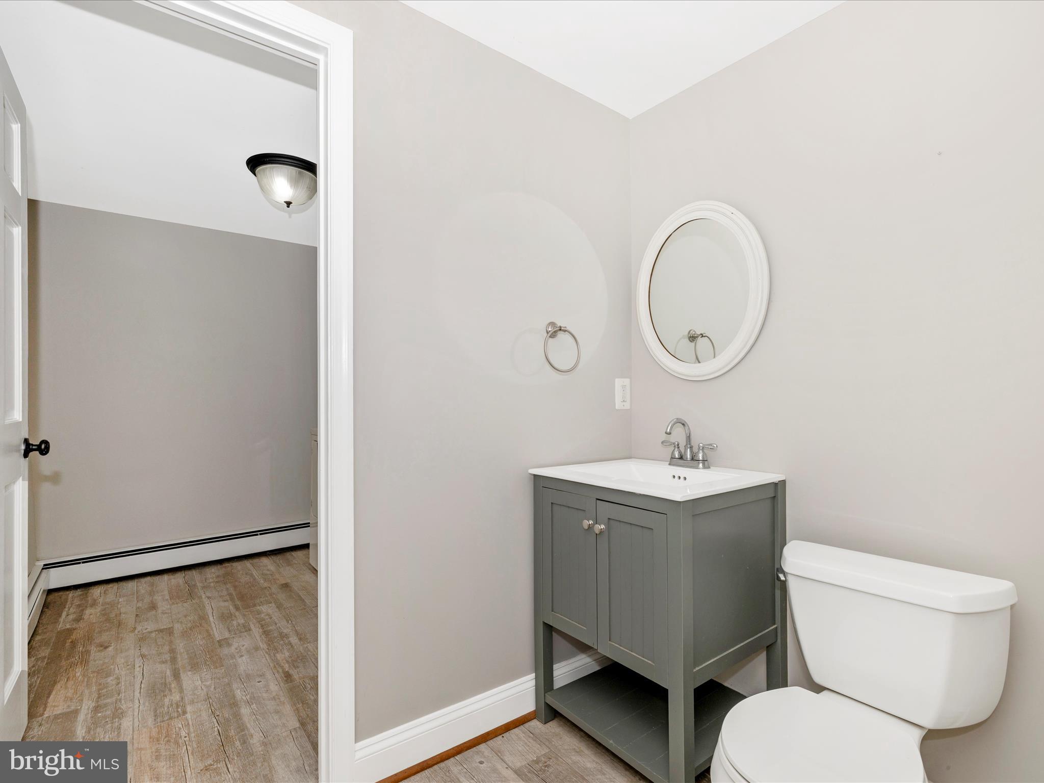 12261 Baugher Road Thurmont, MD 21788 - Photo 23 of 61 a bathroom with a toilet sink and mirror