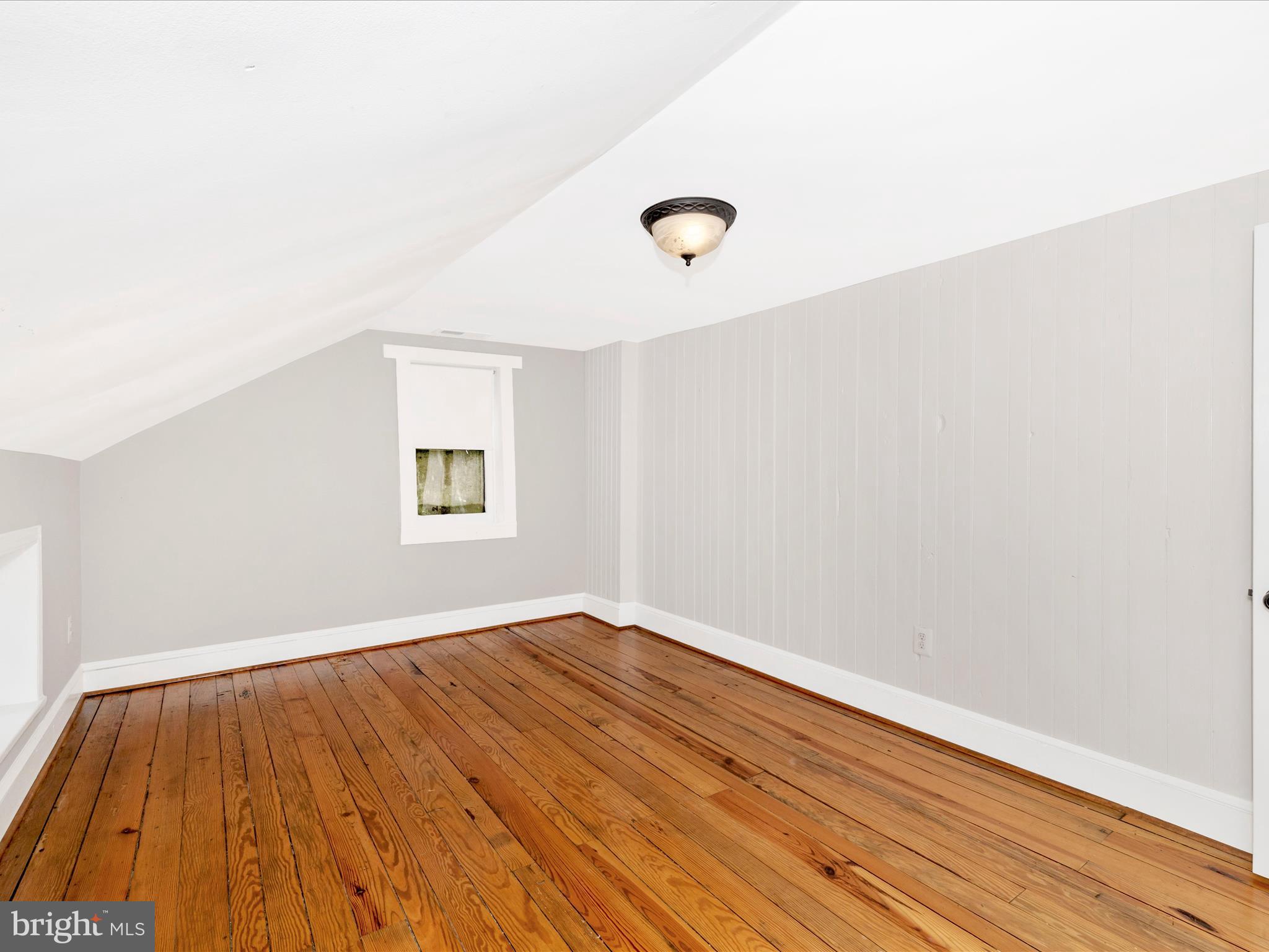 12261 Baugher Road Thurmont, MD 21788 - Photo 36 of 61 an empty room with wooden floor and windows