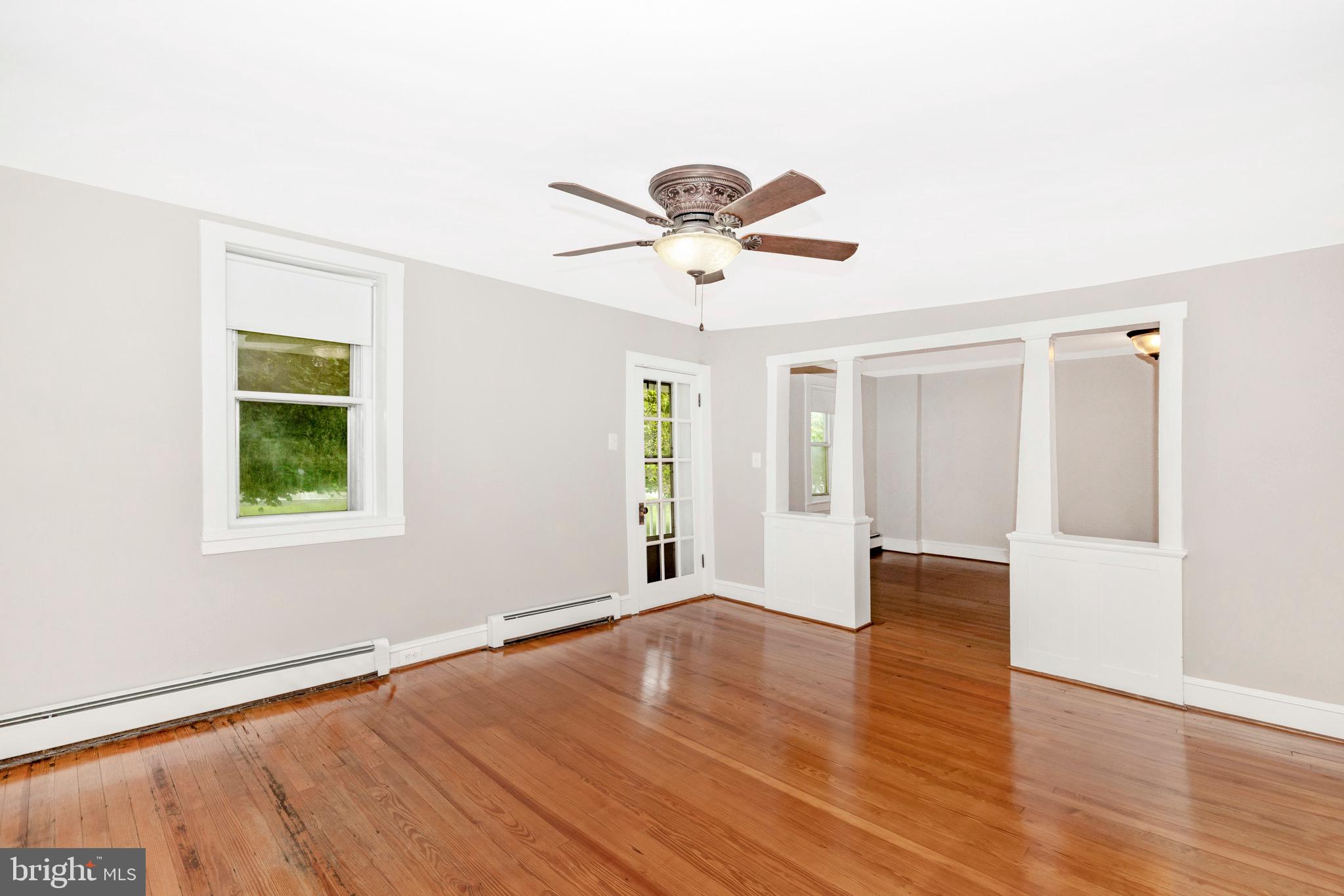 12261 Baugher Road Thurmont, MD 21788 - Photo 6 of 61 a view of an empty room with window and wooden floor
