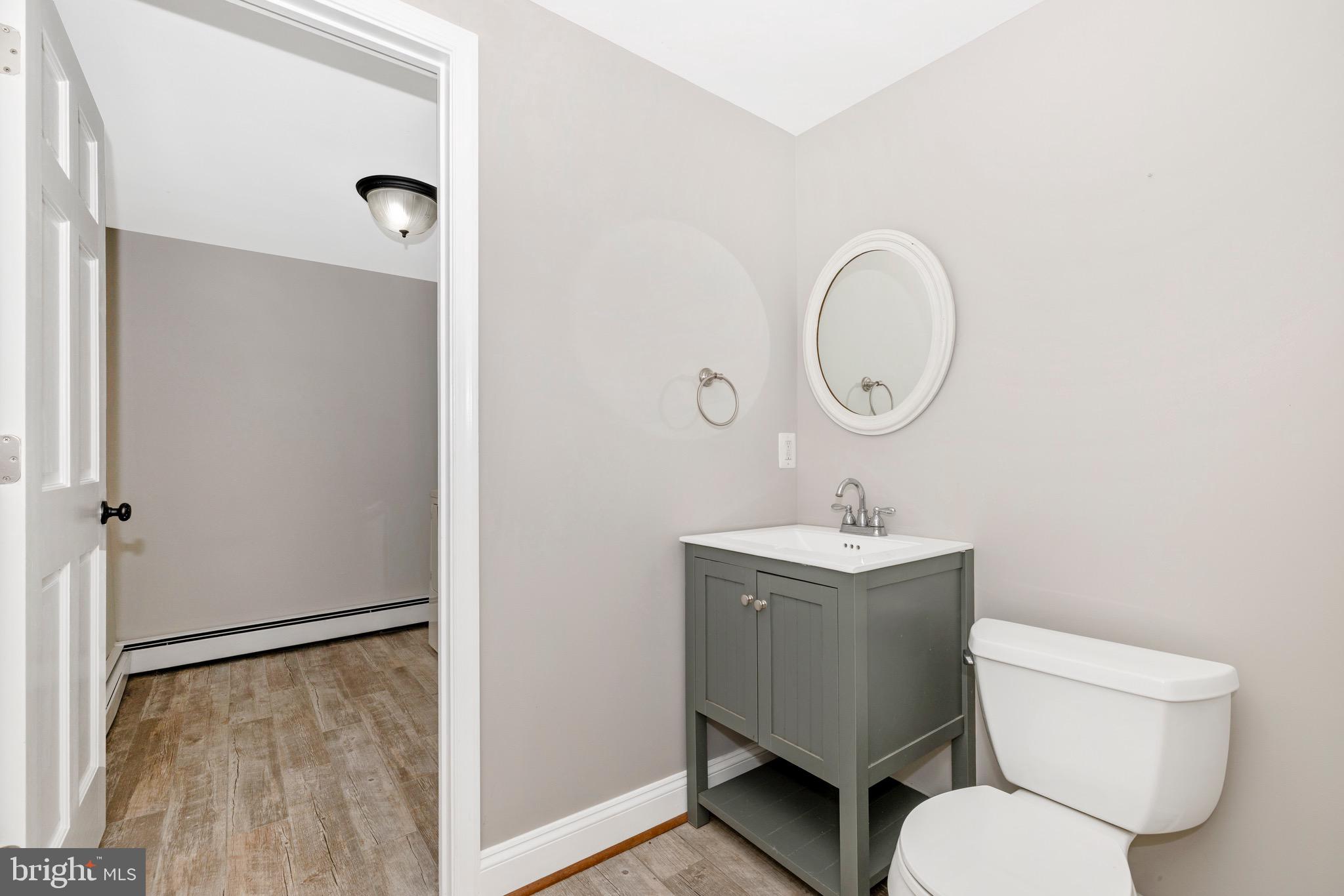 12261 Baugher Road Thurmont, MD 21788 - Photo 9 of 61 a bathroom with a toilet sink and mirror