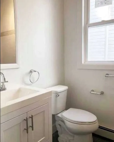 a bathroom with a toilet sink and a window