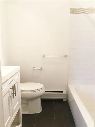 a bathroom with a sink a toilet and bathtub