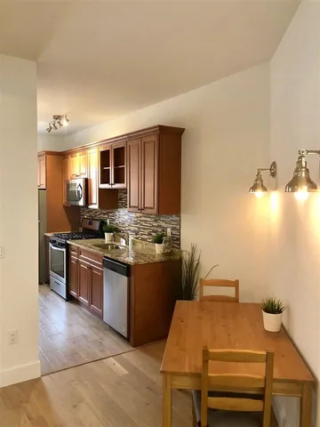 a kitchen with a sink appliances and cabinets