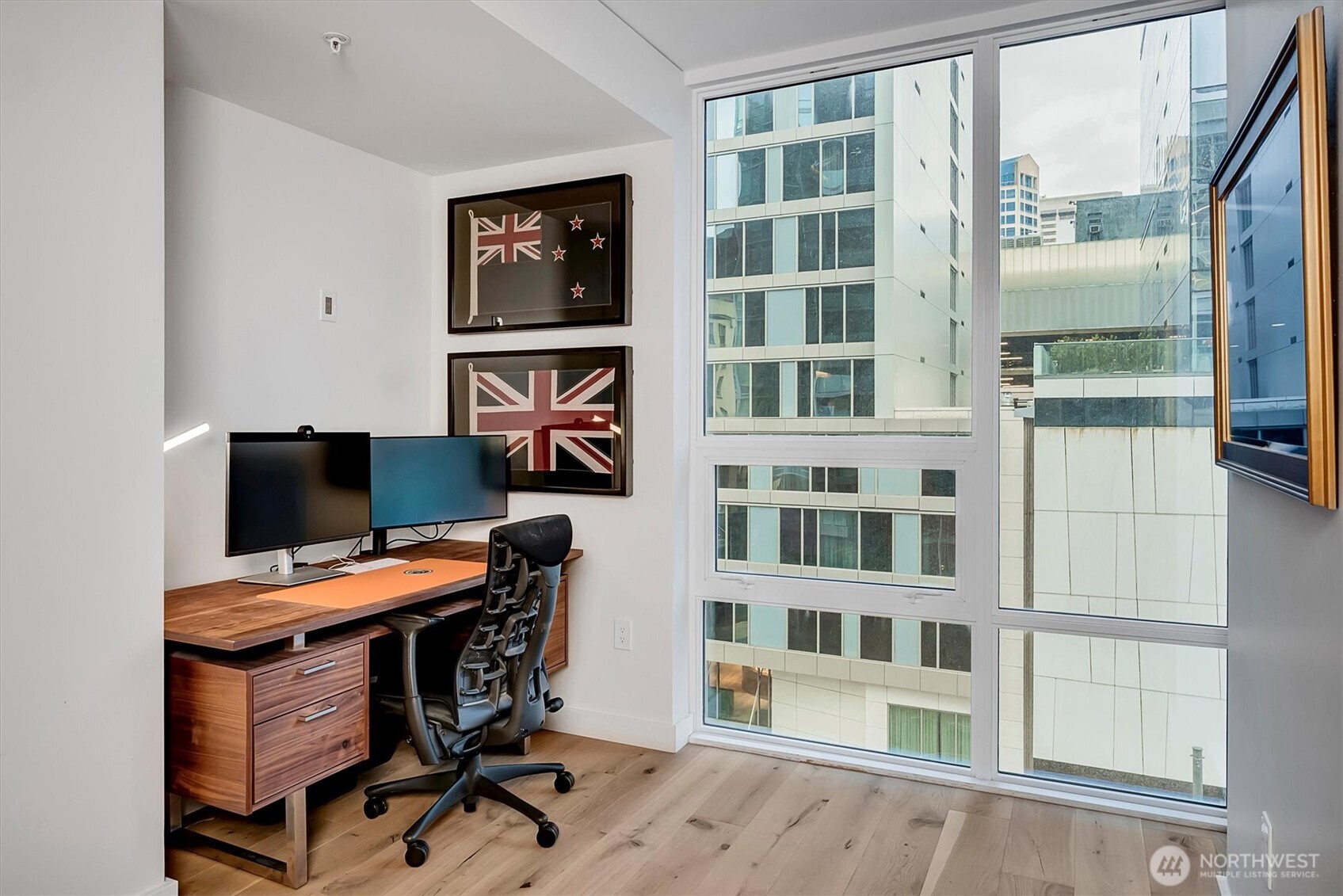 121 Stewart Street, Unit 504 Seattle, WA 98101 - Photo 11 of 27 a view of a workspace with furniture and a window