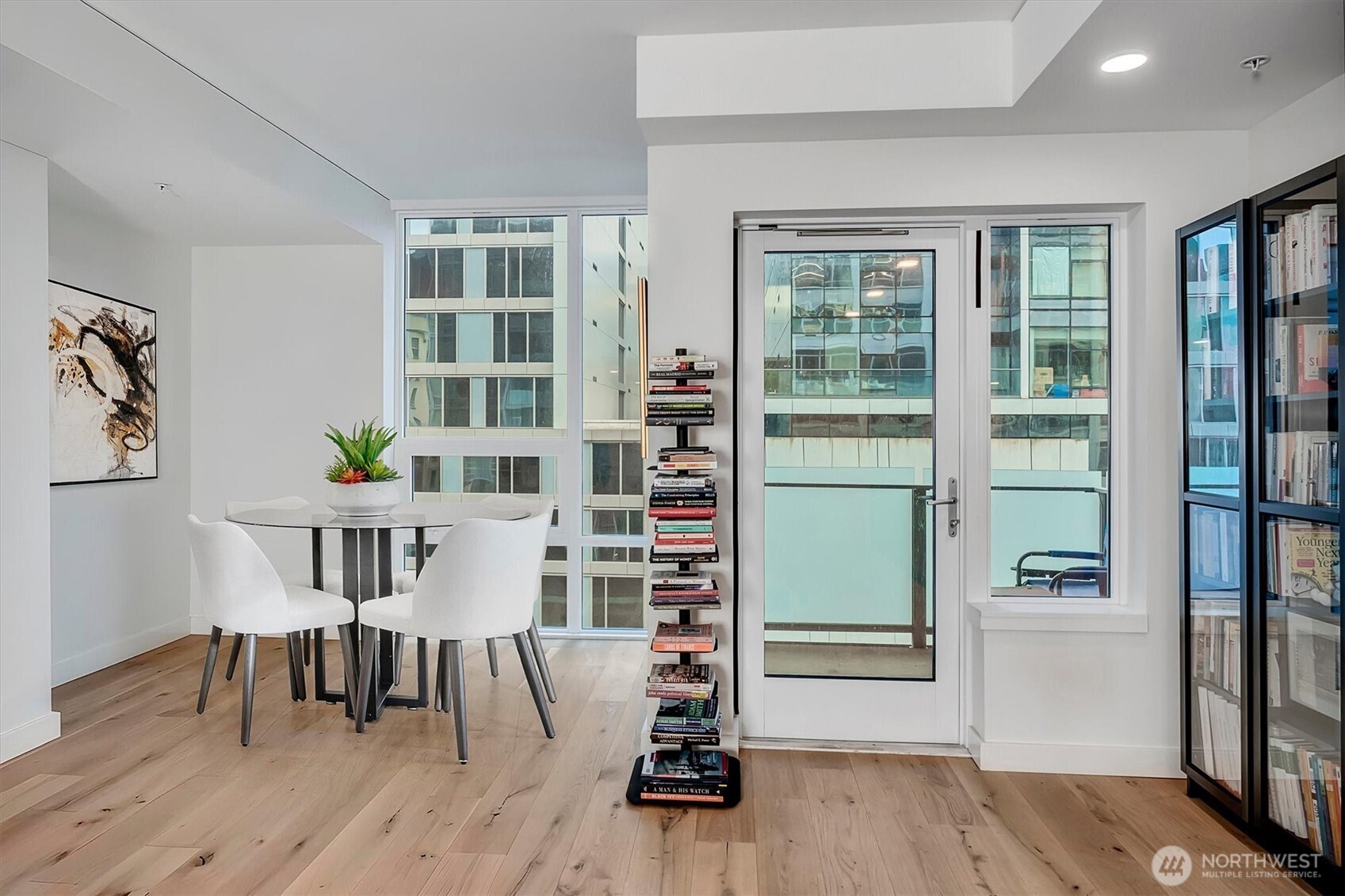 121 Stewart Street, Unit 504 Seattle, WA 98101 - Photo 15 of 27 a view of a dining room with furniture and wooden floor