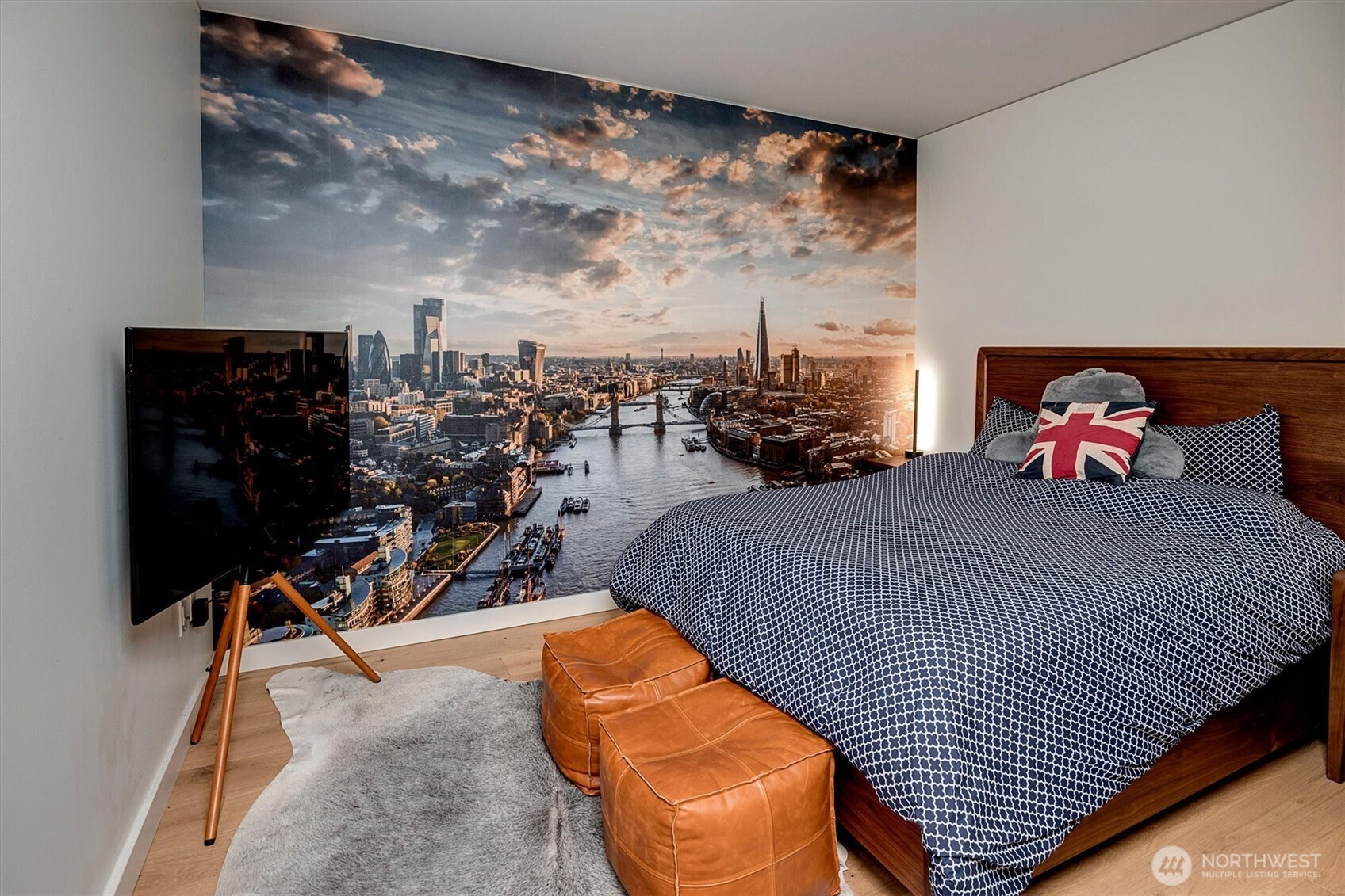 121 Stewart Street, Unit 504 Seattle, WA 98101 - Photo 16 of 27 a bed room with a bed and a chair