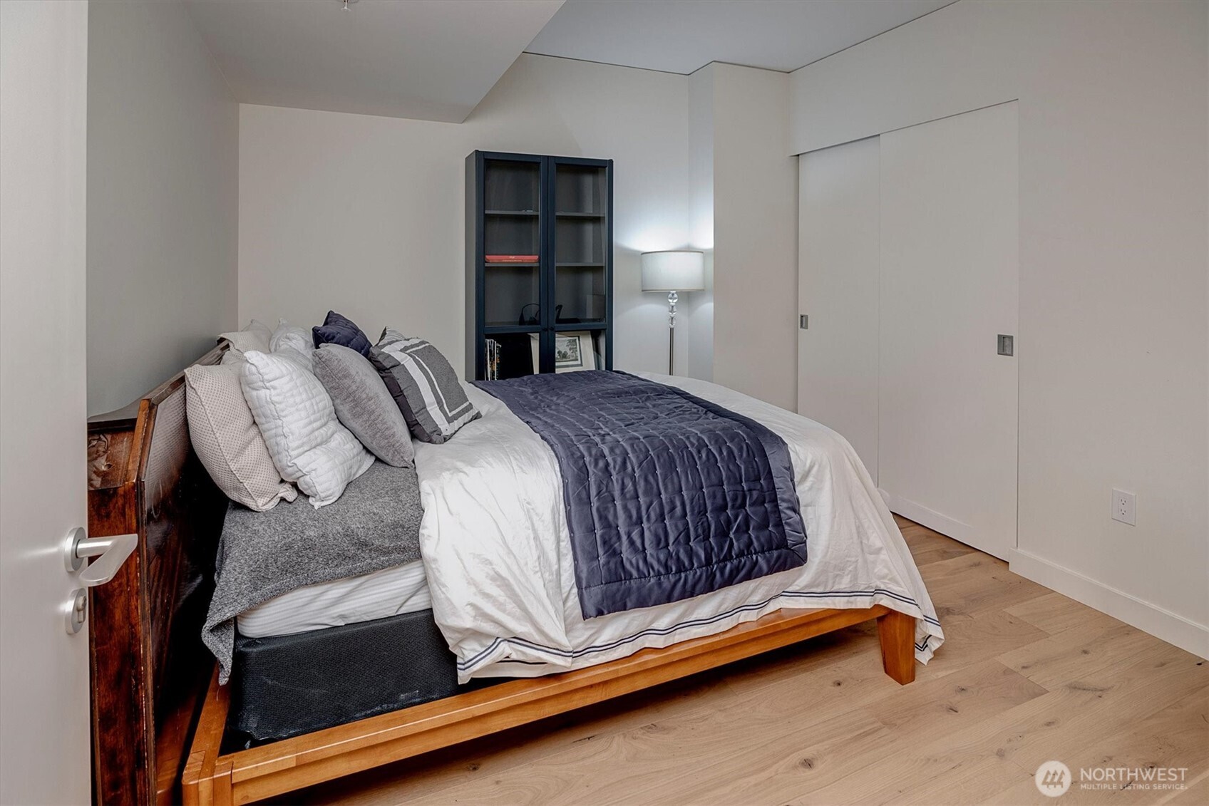 121 Stewart Street, Unit 504 Seattle, WA 98101 - Photo 17 of 27 a bedroom with a bed and a window