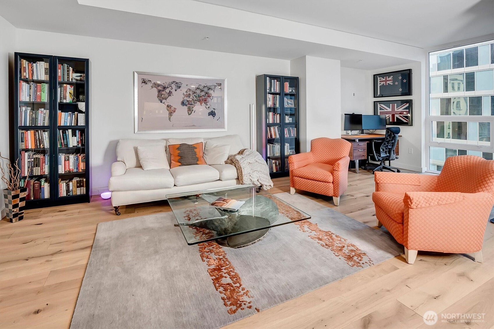 121 Stewart Street, Unit 504 Seattle, WA 98101 - Photo 6 of 27 a living room with furniture and book shelf