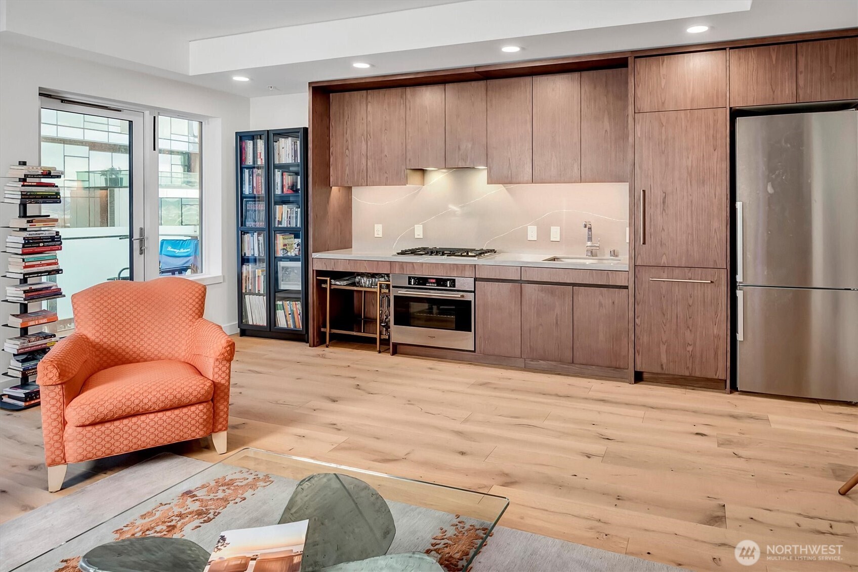 121 Stewart Street, Unit 504 Seattle, WA 98101 - Photo 8 of 27 a kitchen with stainless steel appliances granite countertop a refrigerator and a couch