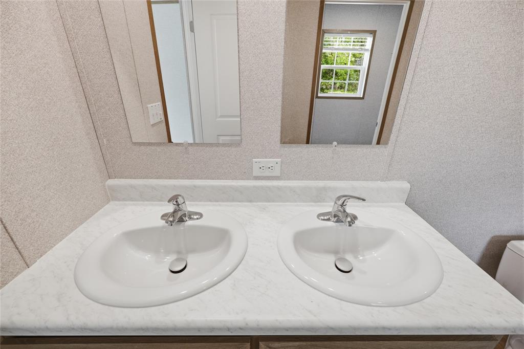 150 19th Street Interlachen, FL 32148 - Photo 18 of 30 a bathroom with 2 sink and a mirror