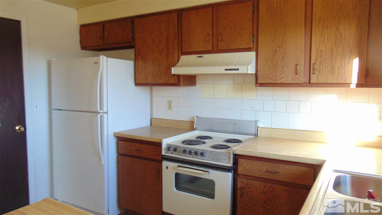 178 Roughing It Road Dayton, NV 89403 - Photo 9 of 14 a kitchen with stainless steel appliances granite countertop a refrigerator stove a sink and dishwasher
