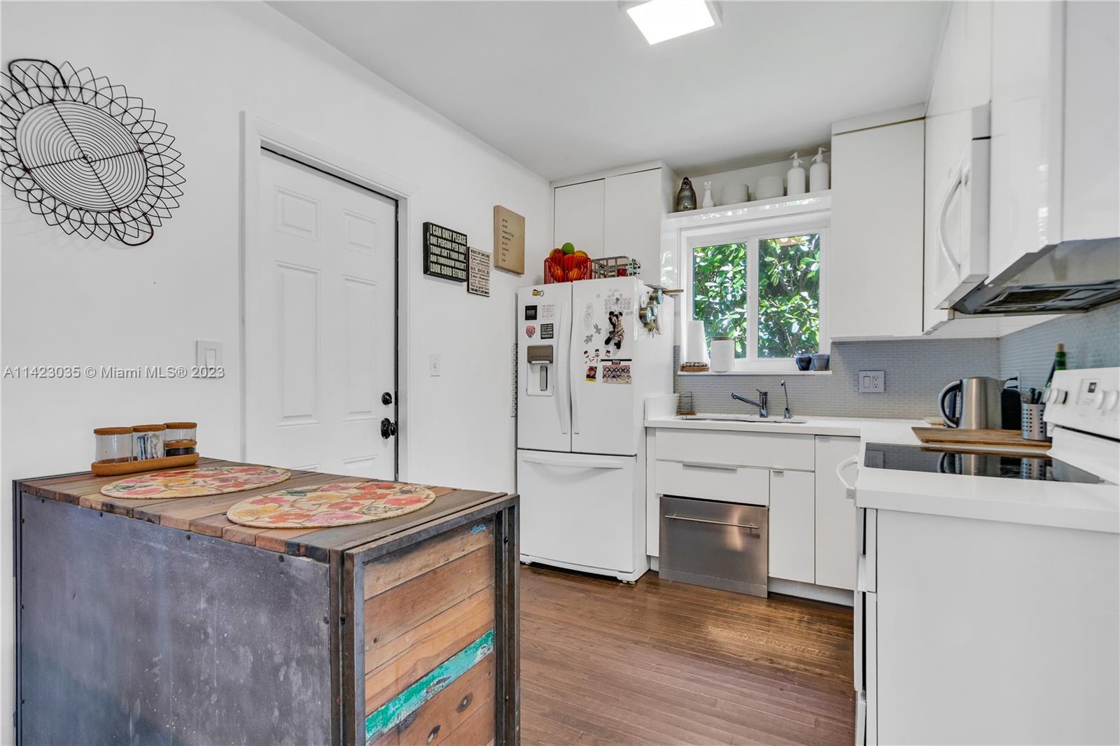 419 Southwest 30th Road, Unit 419 Miami, FL 33129 - Photo 8 of 21 a kitchen with stainless steel appliances granite countertop a stove a sink and a refrigerator