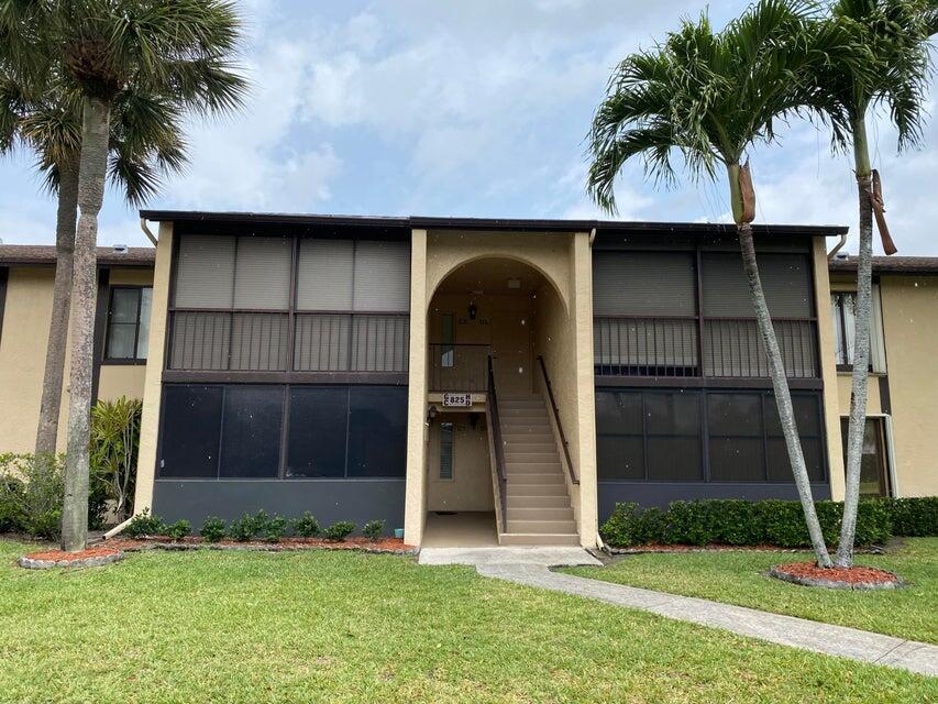 825 Sky Pine Way, Unit C1 Greenacres, FL 33415 - Photo 1 of 18 a front view of a house with a garden