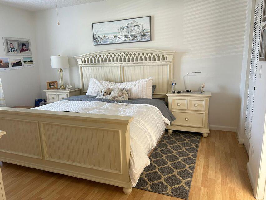 825 Sky Pine Way, Unit C1 Greenacres, FL 33415 - Photo 15 of 18 a bedroom with a bed and a window