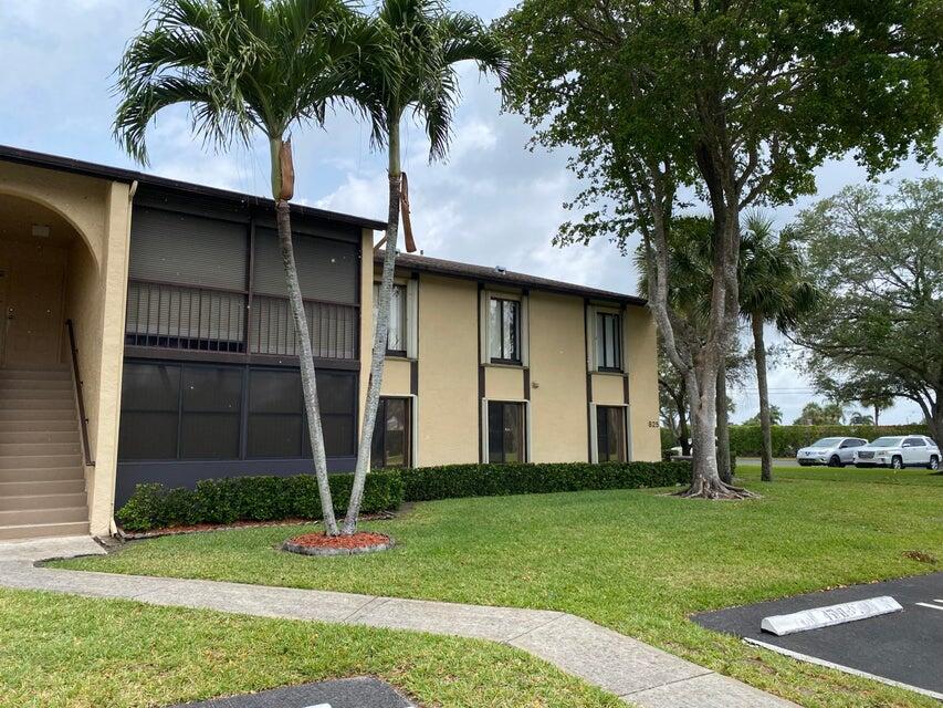 825 Sky Pine Way, Unit C1 Greenacres, FL 33415 - Photo 3 of 18 a front view of a house with garden