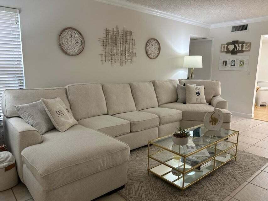 825 Sky Pine Way, Unit C1 Greenacres, FL 33415 - Photo 6 of 18 a living room with furniture a clock on wall and a window