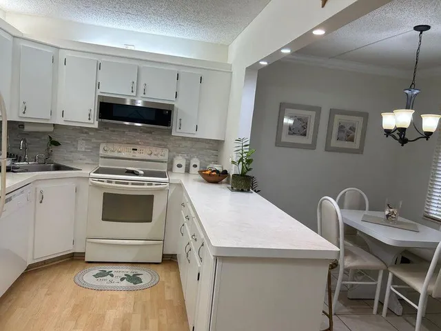 a kitchen with a stove a sink and a refrigerator
