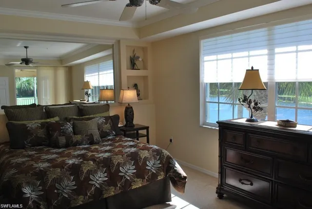 a bedroom with a bed and large window