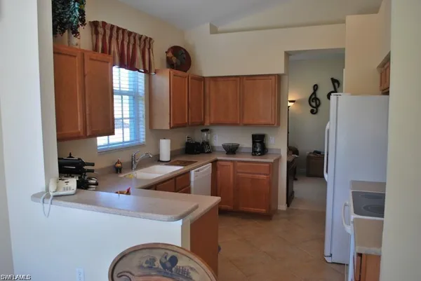 a kitchen with a refrigerator and a sink
