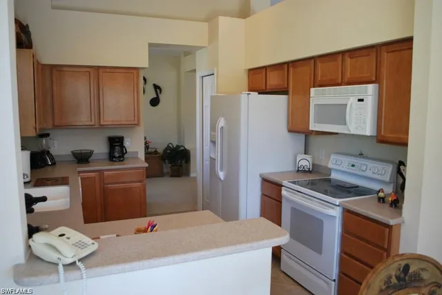 a kitchen with a refrigerator sink and stove