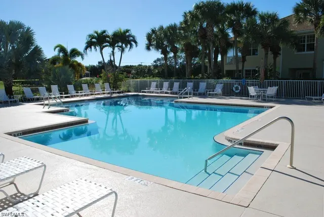 a view of a swimming pool with lounge chair