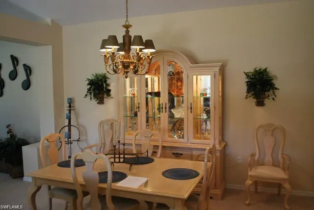 a view of a dining room with furniture and chandelier