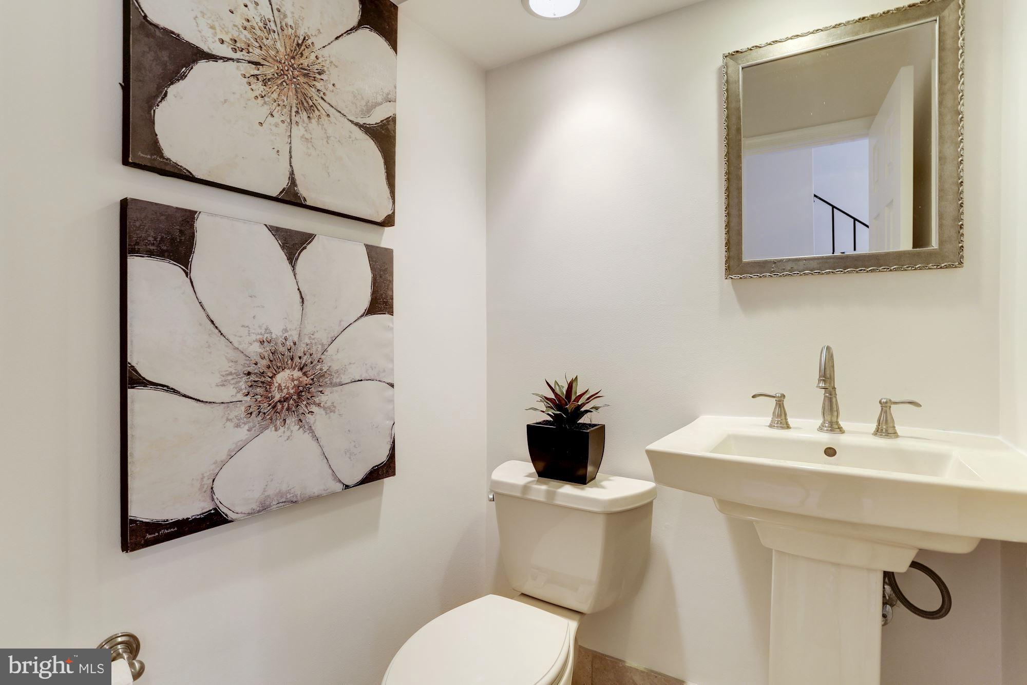 10239 Gainsborough Road Potomac, MD 20854 - Photo 12 of 21 a bathroom with a toilet sink and mirror